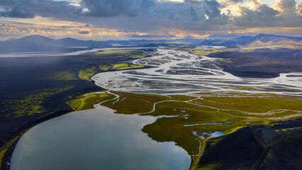 Aerial View of Iceland's Winding River, Lake, and Volcanic Terrain