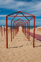 Symmetry of Red Poles and Striped Cabins by the Sea