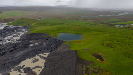 Aerial View of Iceland's Green Fields and Volcanic Terrain