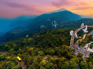 Scenic view of ba na hills with golden bridge and lush forest in Da nang, Vietnam at sunset
