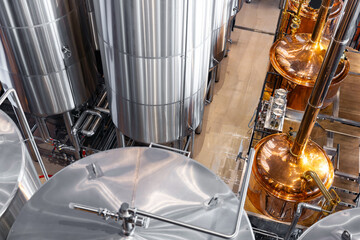 Fototapeta premium Industrial brewery facility with stainless steel tanks and copper vessels