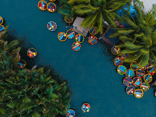 Aerial view of vibrant basket boats with tourist on river in hoi an, vietnam