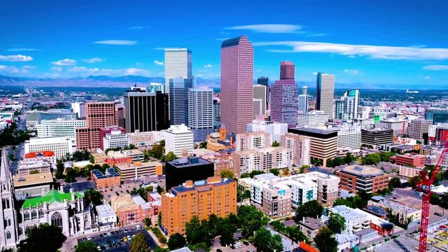 Denver colorado skyline with the rocky mountains in the background on a sunny day