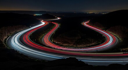 Night Highway Lights Trails, Winding Road in Desert Landscape, Long Exposure Photography, Dynamic Traffic Flow.