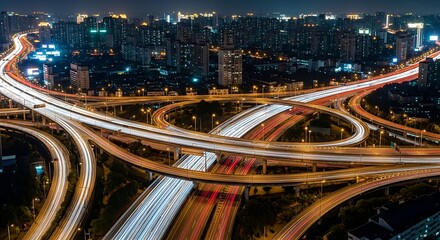 Night City Highway Interchange: Aerial View of Traffic Light Trails and Urban Skyline.