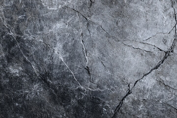 Obraz premium Dark grey stone texture with cracks and fissures a natural rock surface background