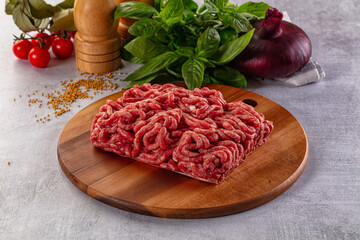 Raw minced beef meat over board