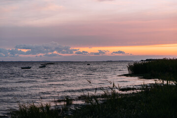 a beautiful orange sunset on the beach of North sea. The sun sets in the sea in the north.