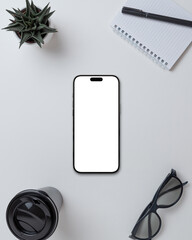 Smartphone with blank screen on office desk with accessories