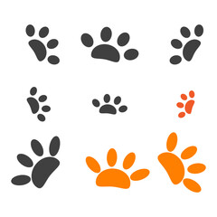 A seamless vector illustration features a repeating pattern of black animal paw prints in the sand, showing the detailed footprints of a cat, dog, and bear