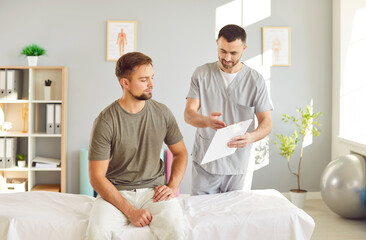 Fototapeta premium Doctor or nurse provides consultation and advice to a patient during a rehabilitation session in hospital. Medical care, support and therapy, during the rehabilitation process in a healthcare office.