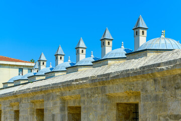 View of a fragments of domes and pipes of baths Blue Mosque or Sultanahmet against the backdrop of a cloudless sky, Turkey, Istanbul. Turkish bath, hammam, spa, relaxation.