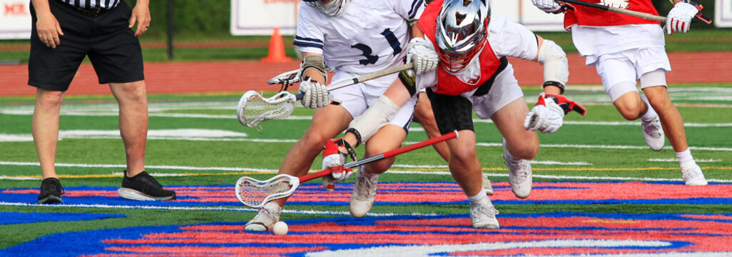 Intense Youth Lacrosse Match With Players Competing for the Ball