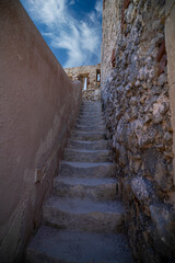 Steps leading up through ancient stone walls in Castello Maniace, Syracuse Sicily Italy.