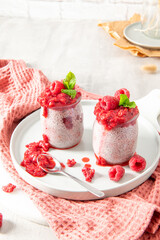 Raspberry chia seed pudding with pink towel and copy space