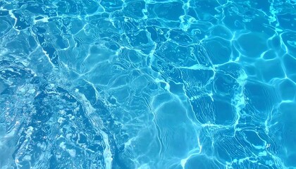 Obraz premium Close-up of a textured water surface, reflecting light and creating vibrant blue patterns