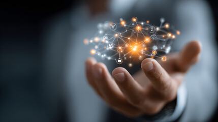Hand holding holographic network of interconnected nodes and icons, symbolizing business innovation and technology. glowing elements convey sense of futuristic connectivity
