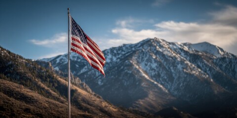 American flag waving proudly against a backdrop of majestic snow-capped mountains in the afternoon light