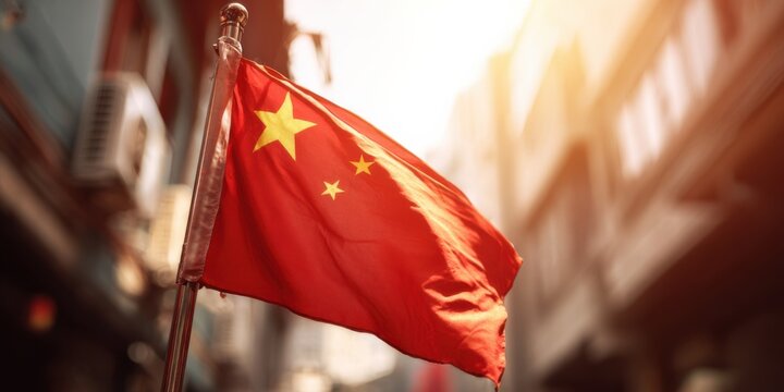 Chinese flag waving in urban street during golden hour sunlight enhancing the vibrant colors
