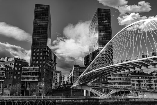 Black and white view of Zubizuri bridge and towers in Bilbao.