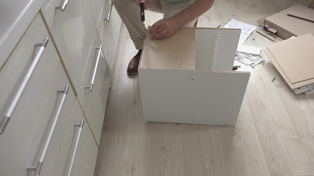 Preparing to assemble a piece of furniture, front view