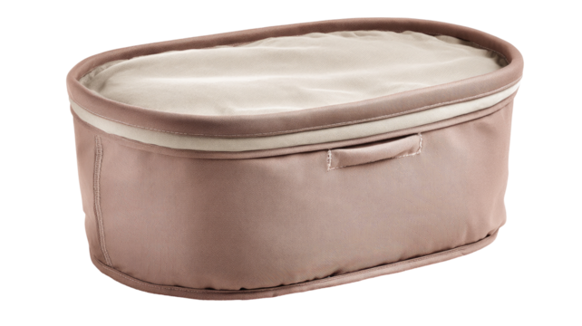 Oval, blush-pink storage basket with cream liner