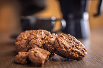 Sweet chocolate cookies on wooden table.