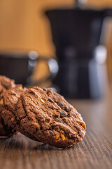 Sweet chocolate cookies on wooden table.