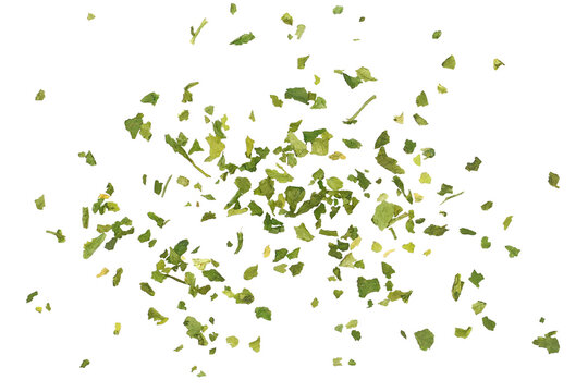 Close up chopped dry parsley leaves flying, pile isolated on white background, clipping path