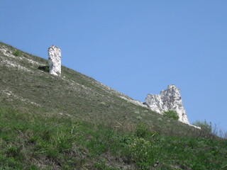 Rocky formations on hillside under clear blue sky  