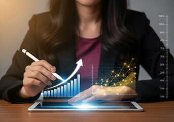Businesswoman analyzing financial growth chart on tablet with glowing data visualization and upward arrow