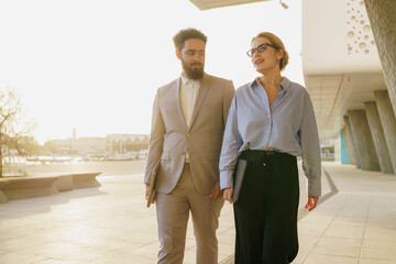A group of business professionals walking together in a bustling and modern urban environment