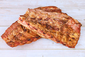 Smoked flavorful ribs are seasoned cooked to perfection, showcasing delicious crust smoky aroma.