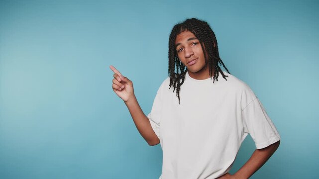 footage of young man points with his finger in an expressive manner, suggesting a message or idea on blue background