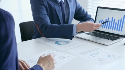 Business team of several colleagues discussing financial data on a laptop while analyzing charts and market trends in office. Businesspeople and finance concept - Powered by Adobe