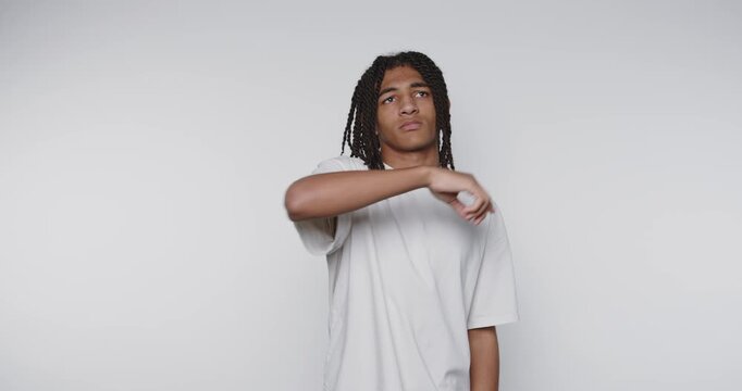 footage of young contemplative man is thoughtfully pointing upward on white background - Powered by Adobe