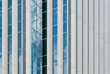 Detailed view of a modern high-rise building in downtown Saskatoon, Canada, showing vertical white...