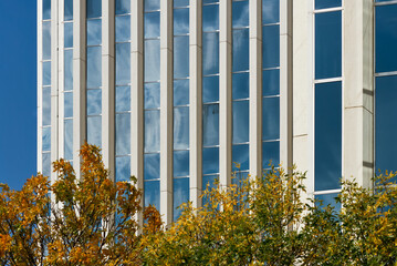 Low angle view of a modern skyscraper in downtown Saskatoon, Canada, featuring white facade with...