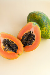 Juicy papaya fruit with seeds. Bright, orange juicy fruit in the bottom corner of the photo
