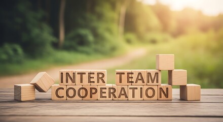 Wooden cubes spelling 'inter team cooperation' showcasing teamwork and collaboration concept