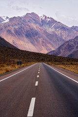 mountain road landscape with snowy peaks in the background
