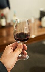close-up of sommelier serving red wine at fine dining restaurant
