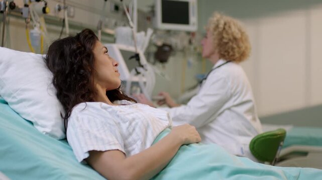 A concerned doctor explains medical information to her patient in a hospital.
