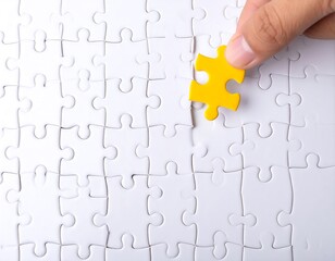 Fototapeta premium A completed jigsaw puzzle with a single, vivid yellow piece ready to be placed.