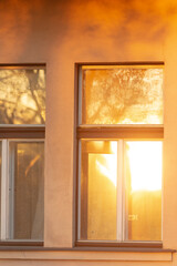 Fototapeta premium A breathtaking view of windows reflecting the warm sunset light, highlighting the interplay of light and shadows on a buildings facade, creating an unforgettable visual experience