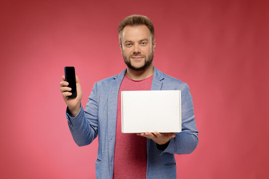 friendly business man with white box and smartphone