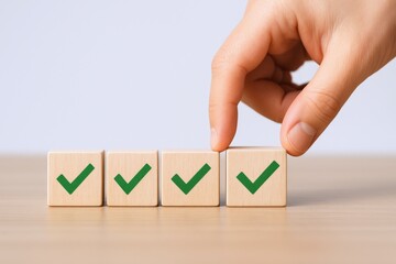 Hand Arranging Wooden Blocks with Green Check Marks: Task Completion and Approval Concept