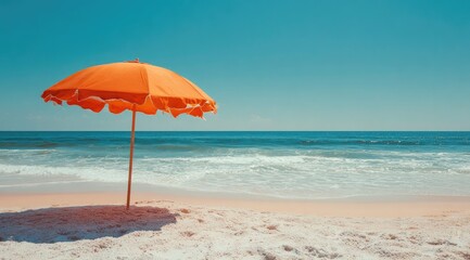 Bright orange beach umbrella on sandy shore