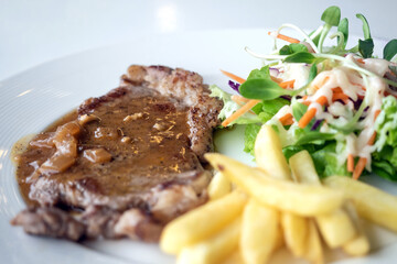 Close up of Grilled beef steak, boiled french fries and vegetable salad;Selective focus