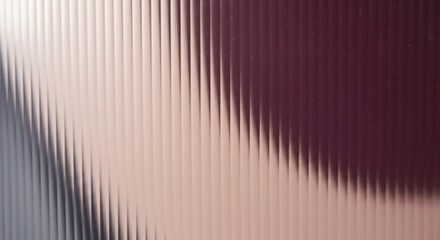 Abstract background of reeded or fluted glass with a vertical pattern. A soft gradient of light pink to deep purple creates a modern and elegant texture.